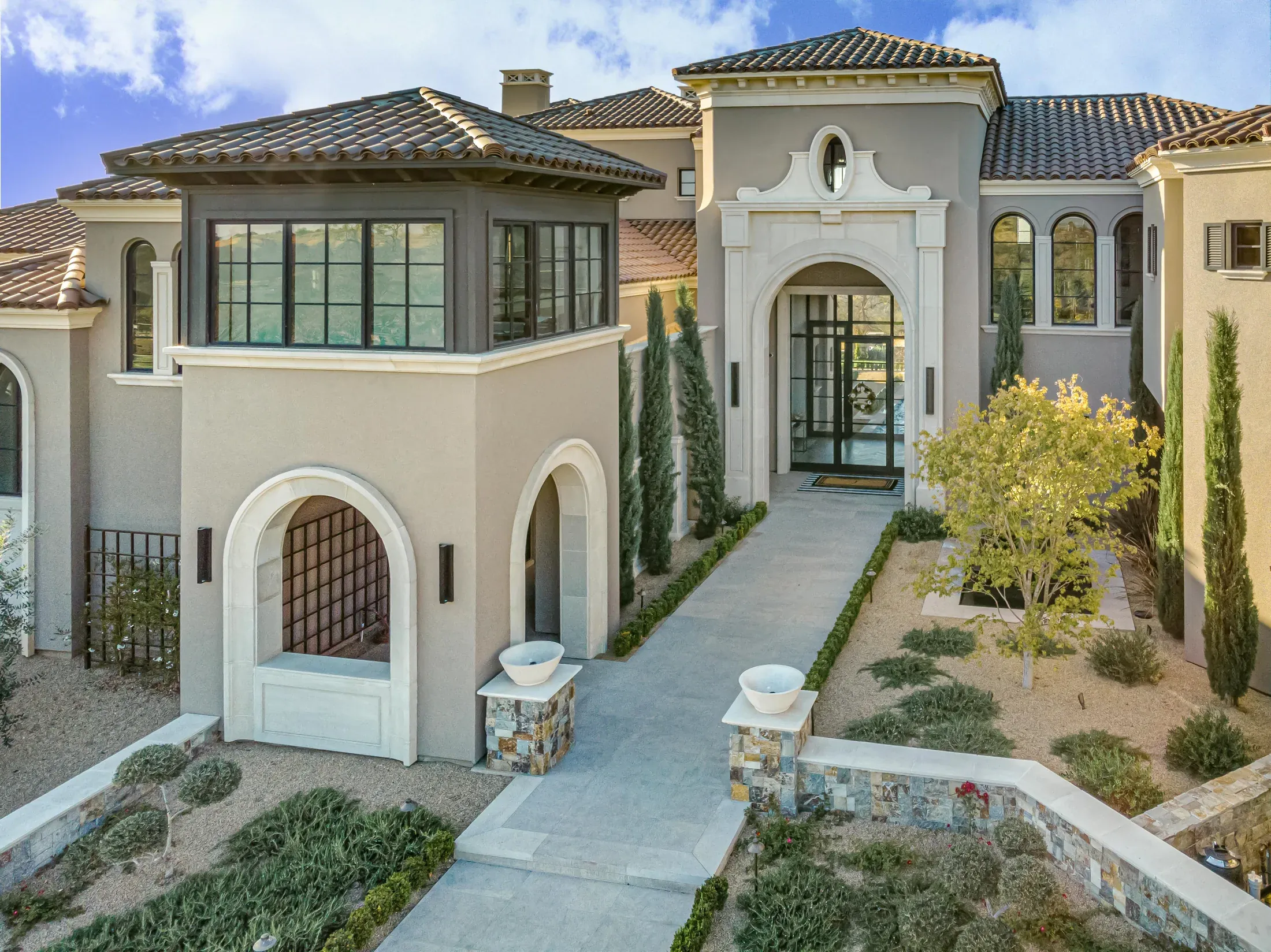 Custom precast stone entry with mouldings, columns, surrounds, and steps